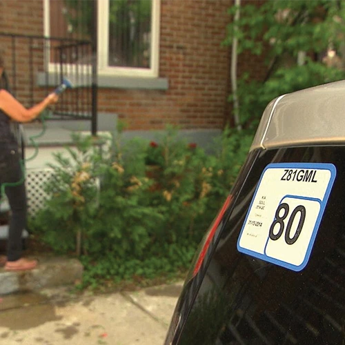 Parking sticker displayed on a vehicle windshield.